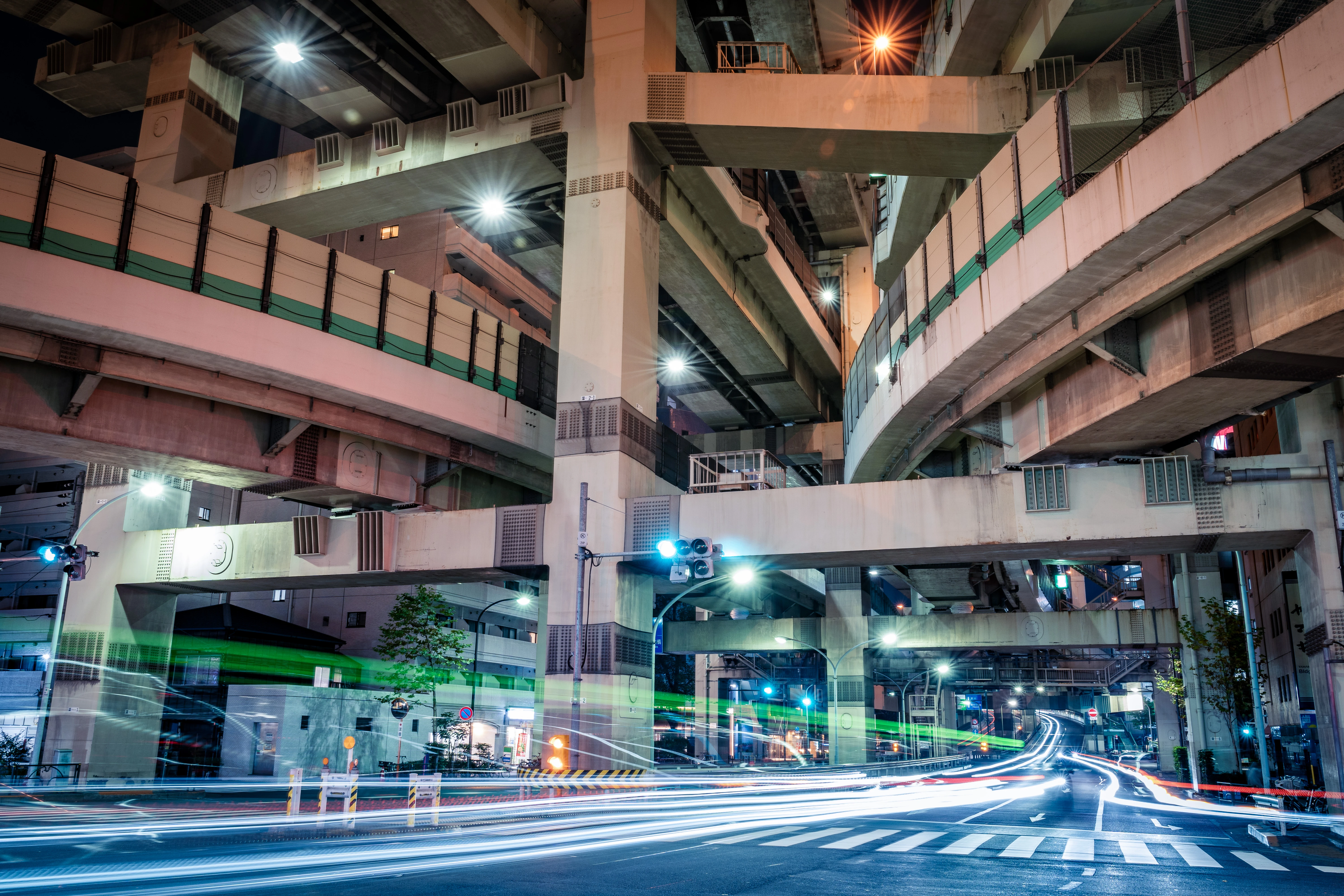 Dynamic Light Trails Under the Layers of an Urban Overpass